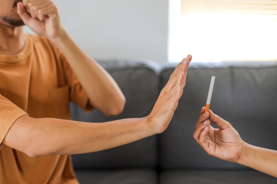 Ex-fumeur qui refuse une cigarette lors d’un moment social, confiant dans son sevrage